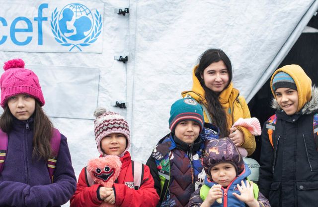 Refugee children in front of their emergency shelter.